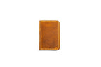 Brown full grain leather minimalist bifold wallet for men and women that holds cash and cards better than a Ridge wallet.
