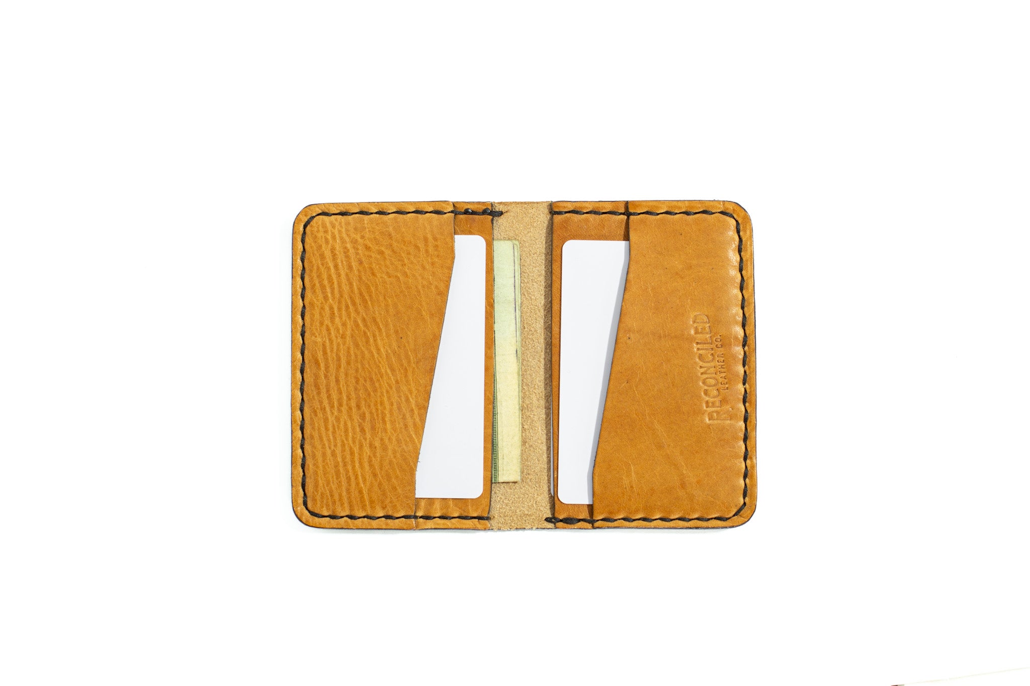 four pocket tan full grain leather minimalist bifold on white background with cards and cash in it